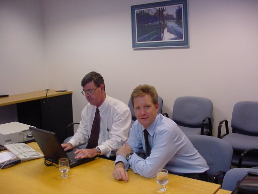 James getting instruction from Neil on 'Employee Connect' in Brisbane conference room.